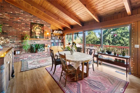 a dining room with furniture and wooden floor