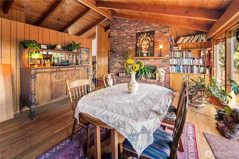 a dining room with furniture and wooden floor