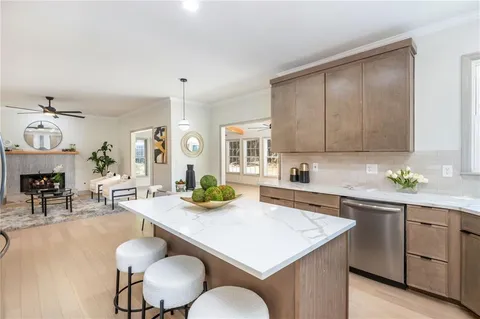 a open kitchen with sink cabinets and dining table with chairs
