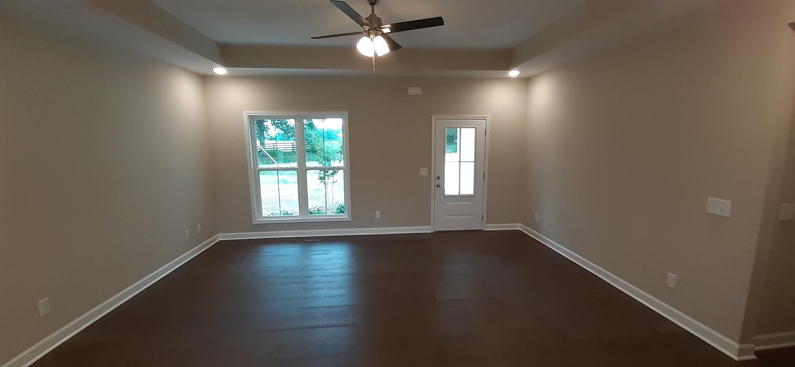 385 Pruett Road Dickson, TN 37055 - Photo 8 of 16 an empty room with wooden floor and windows