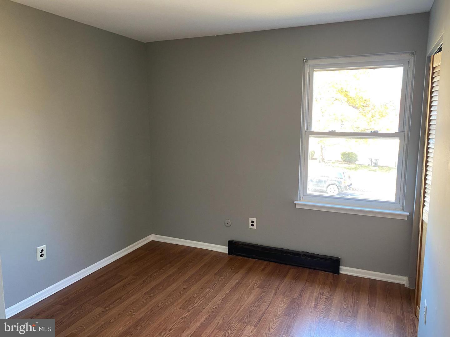 14 Berkshire Road Sicklerville, NJ 08081 - Photo 10 of 15 an empty room with wooden floor and windows