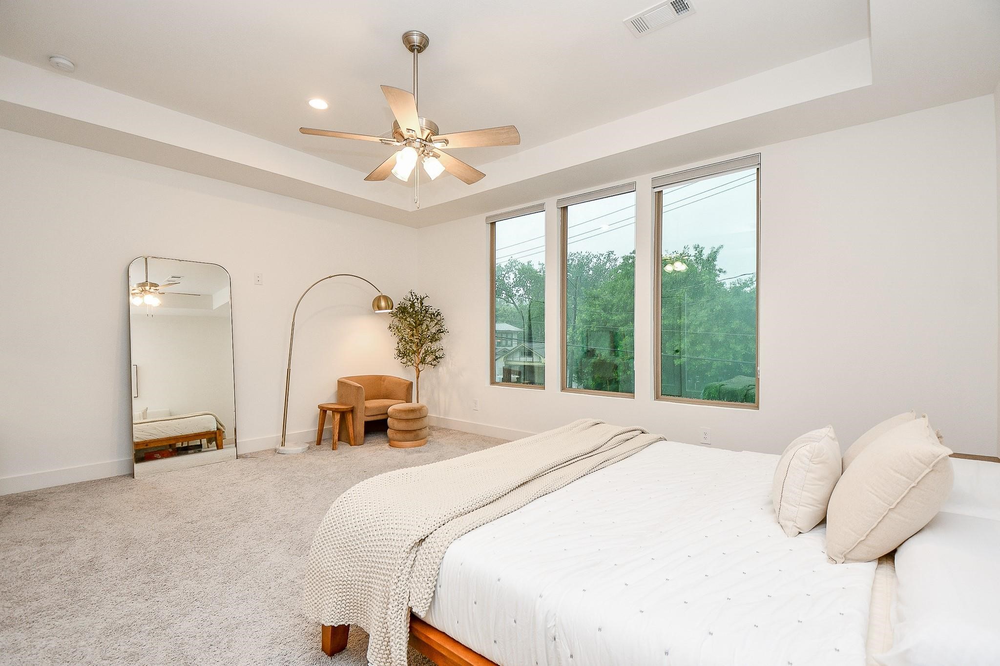 4403 Greeley Street Houston, TX 77006 - Photo 17 of 28 a bedroom with a bed and a chandelier