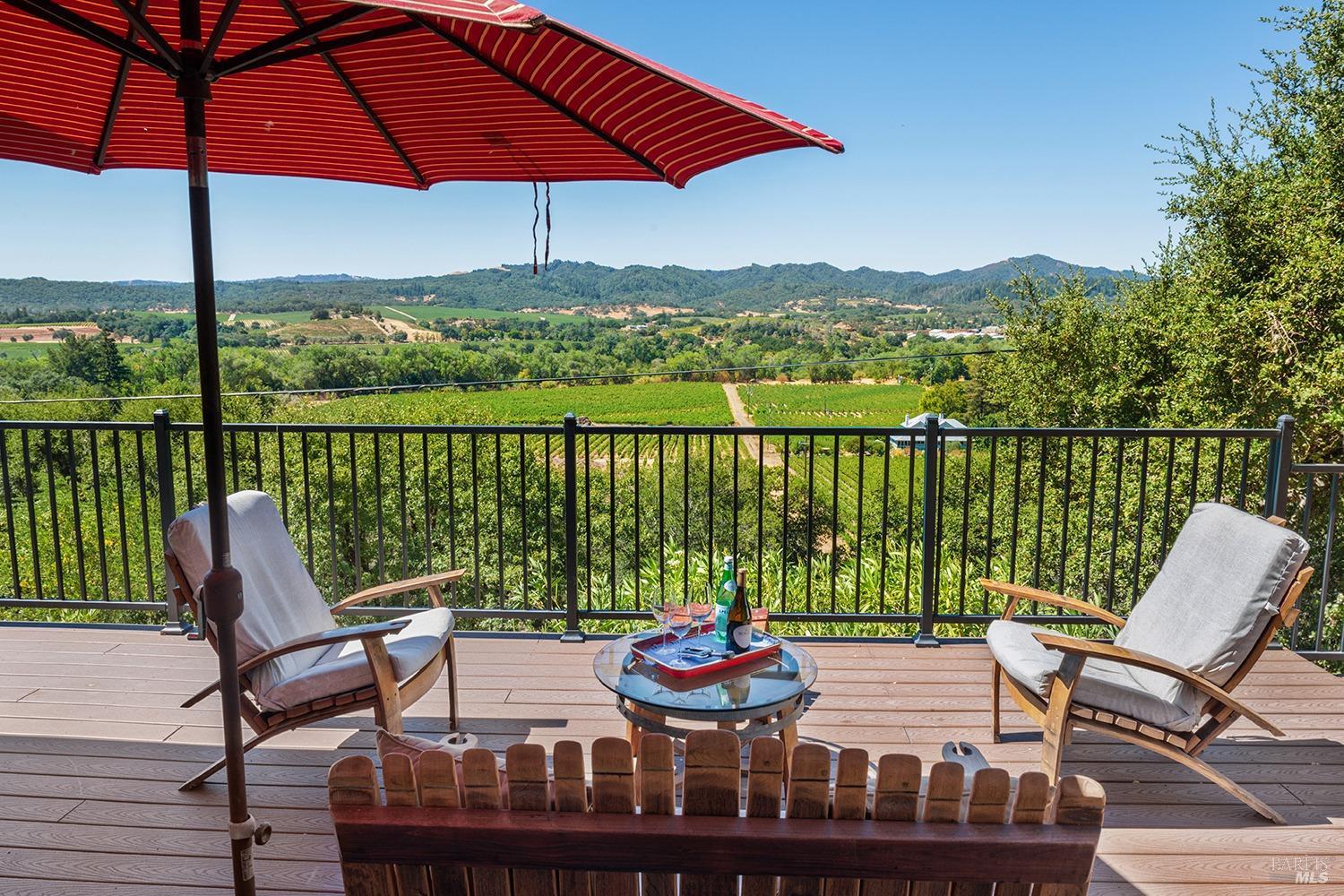 a view of a chair and table on the deck