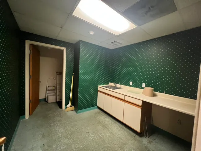 a room with a bed and utility room