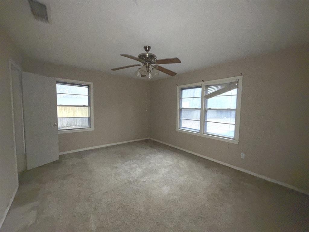 206 Summit Drive Gilmer, TX 75644 - Photo 12 of 23 an empty room with a window and a ceiling fan