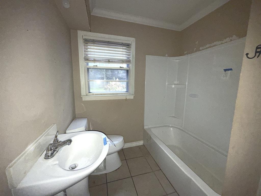 206 Summit Drive Gilmer, TX 75644 - Photo 15 of 23 a white bath tub sitting next to a white sink and a toilet