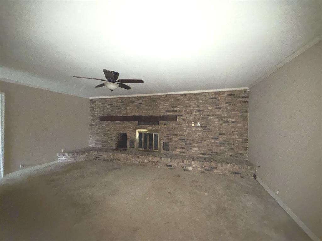 206 Summit Drive Gilmer, TX 75644 - Photo 3 of 23 a view of an empty room with a fireplace