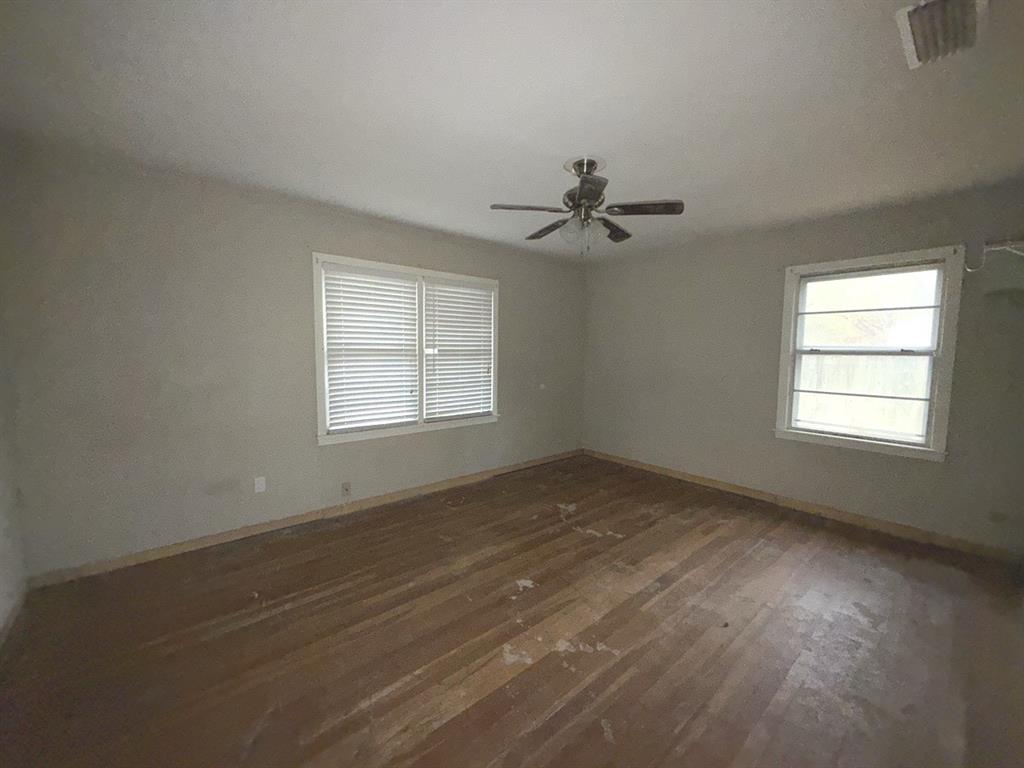 206 Summit Drive Gilmer, TX 75644 - Photo 10 of 23 a view of empty room with wooden floor and fan