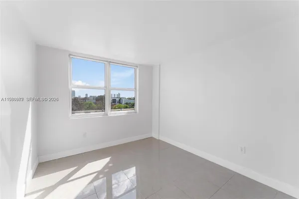 a kitchen with stainless steel appliances granite countertop white cabinets a refrigerator a sink a stove and a refrigerator