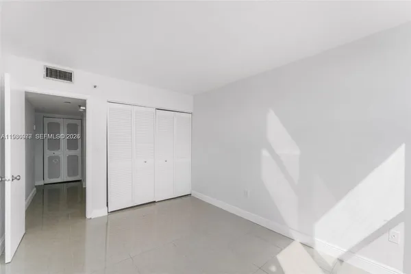 a view of kitchen with refrigerator and window