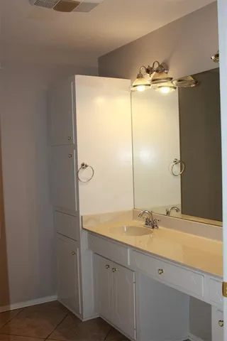 a bathroom with a double vanity sink and mirror
