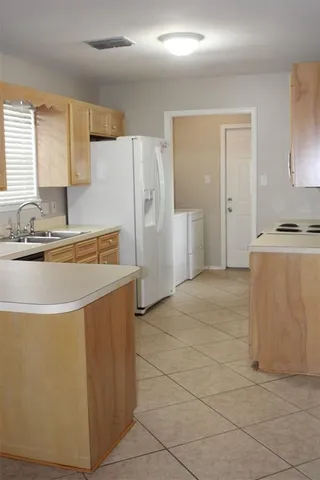 a kitchen with stainless steel appliances a refrigerator sink and cabinets