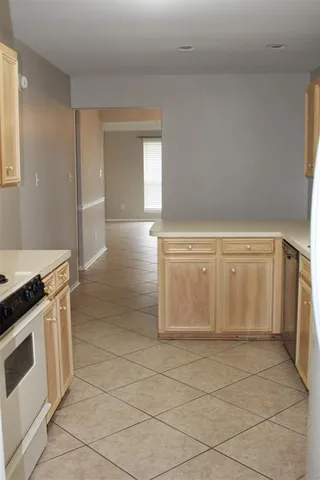 a view of a kitchen with white cabinets