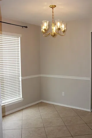 a view of a room with a window and chandelier