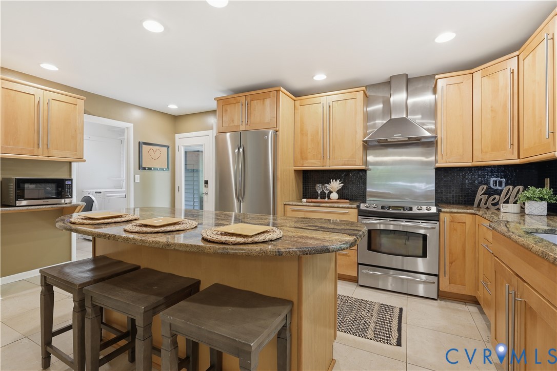 13622 Winterberry Ridge Midlothian, VA 23112 - Photo 15 of 47 a kitchen with stainless steel appliances kitchen island granite countertop a stove a sink a refrigerator and white cabinets
