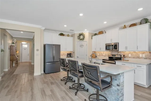a living room with furniture a flat screen tv and a large window
