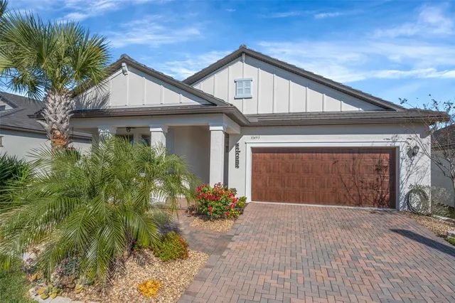 a view of a hallway with wooden floor and a living room