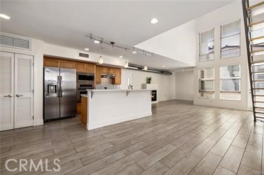 536 North Brea Boulevard Brea, CA 92821 - Photo 10 of 30 a view of a kitchen with stainless steel appliances a refrigerator and a stove top oven