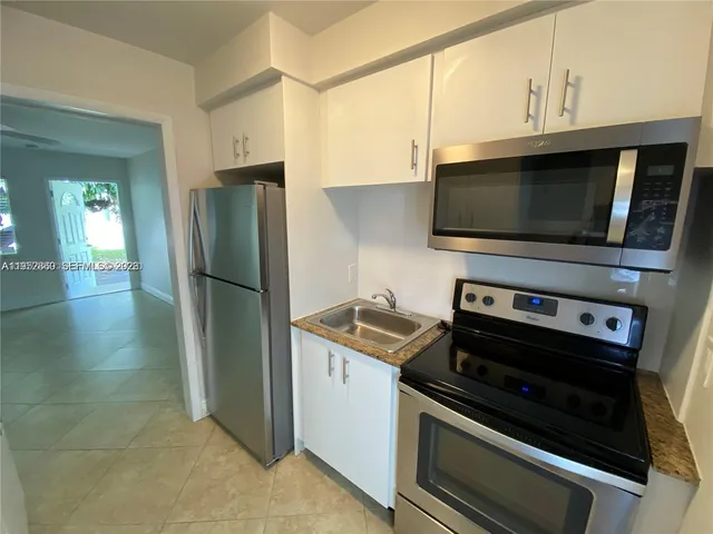a kitchen with a stove and a microwave