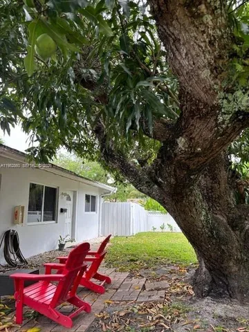 a view of backyard with outdoor seating and green space