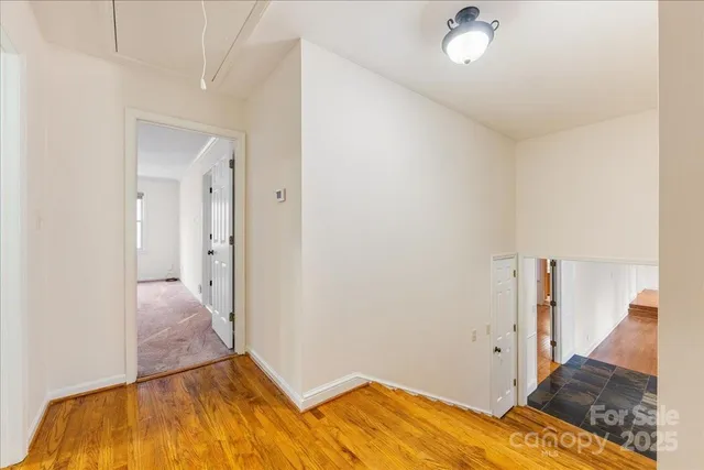 a view of hallway with wooden floor