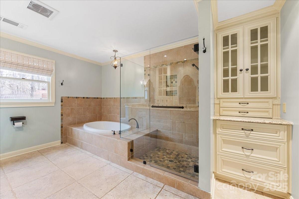 3212 Nancy Creek Road Charlotte, NC 28270 - Photo 18 of 44 a bathroom with a bathtub and a shower