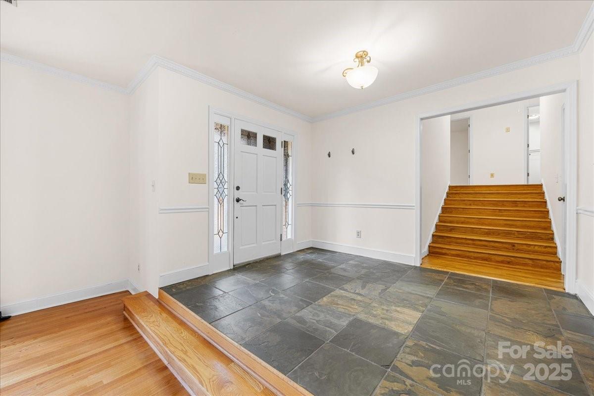 3212 Nancy Creek Road Charlotte, NC 28270 - Photo 2 of 44 an empty room with wooden floor and white walls