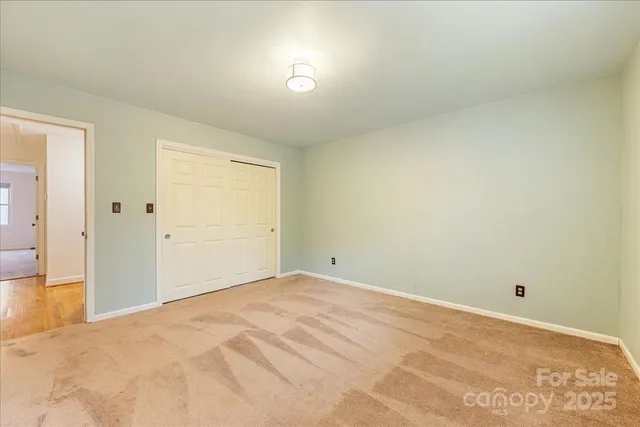 a bathroom with a granite countertop double vanity sink and a mirror