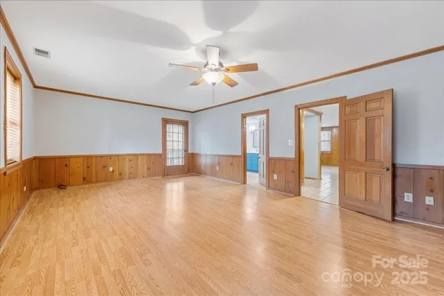 a view of an empty room with closet and a window