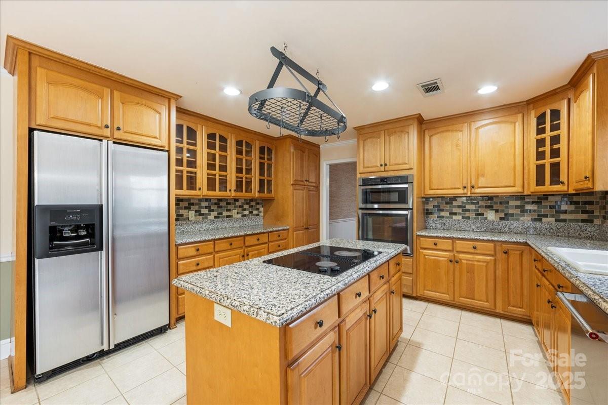 3212 Nancy Creek Road Charlotte, NC 28270 - Photo 5 of 44 a kitchen with stainless steel appliances granite countertop a refrigerator and a stove top oven