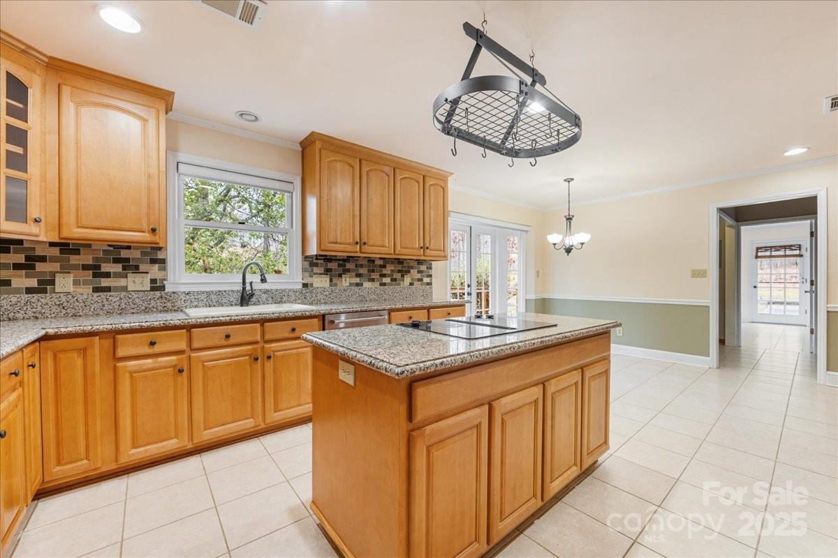 3212 Nancy Creek Road Charlotte, NC 28270 - Photo 7 of 44 a kitchen with stainless steel appliances granite countertop a sink and dishwasher a stove with wooden cabinets