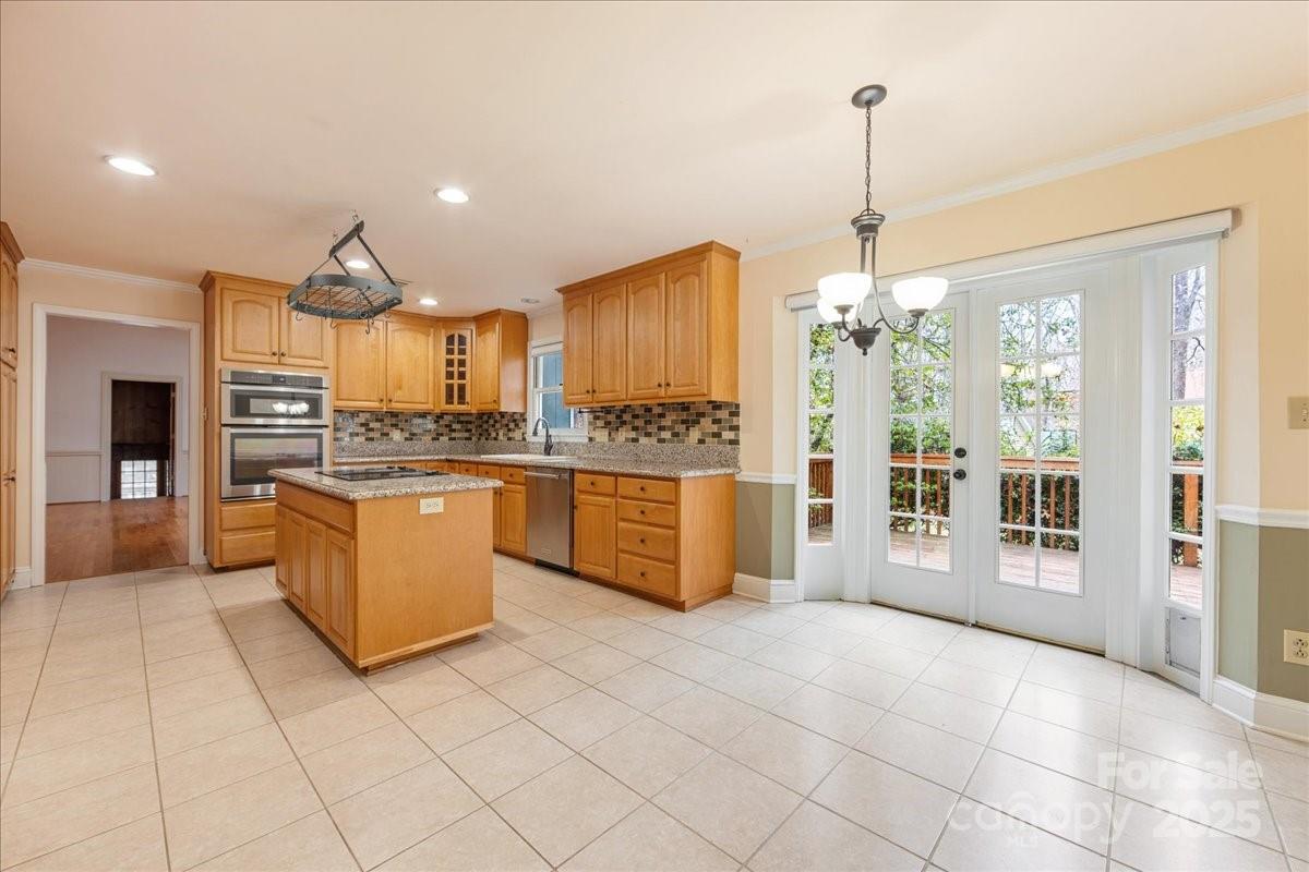3212 Nancy Creek Road Charlotte, NC 28270 - Photo 9 of 44 a kitchen with stainless steel appliances kitchen island granite countertop a refrigerator and a sink