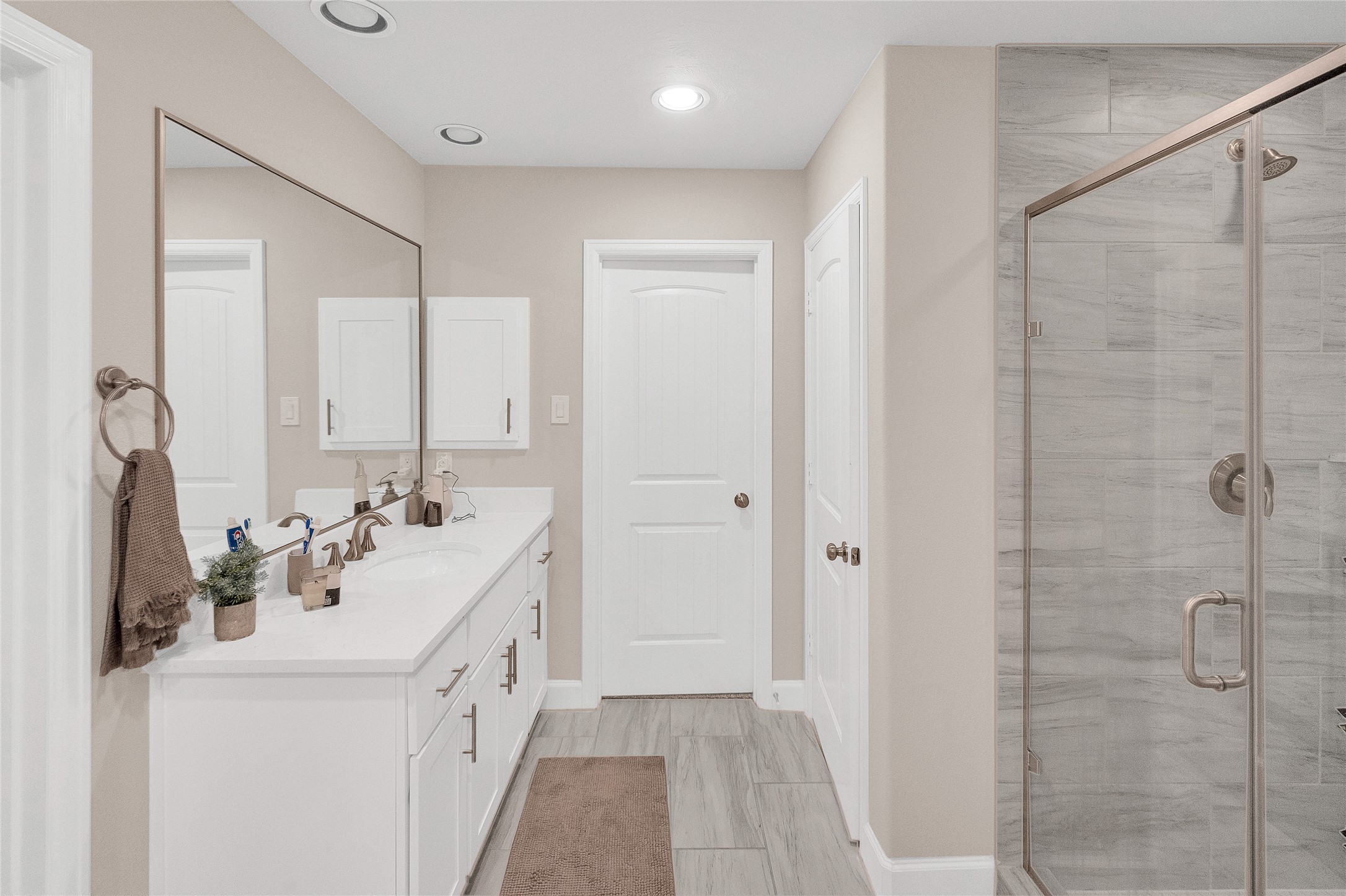 5014 Lillian Street Houston, TX 77007 - Photo 18 of 24 a bathroom with a double vanity sink a mirror and shower