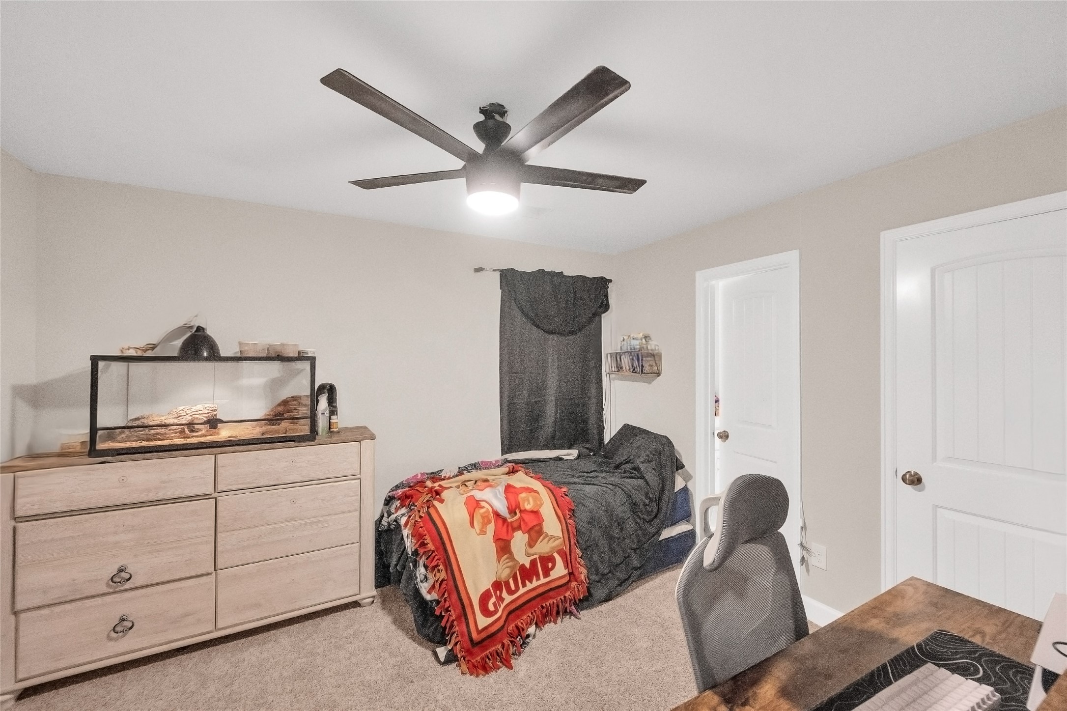 5014 Lillian Street Houston, TX 77007 - Photo 21 of 24 a bedroom with a bed and a chandelier