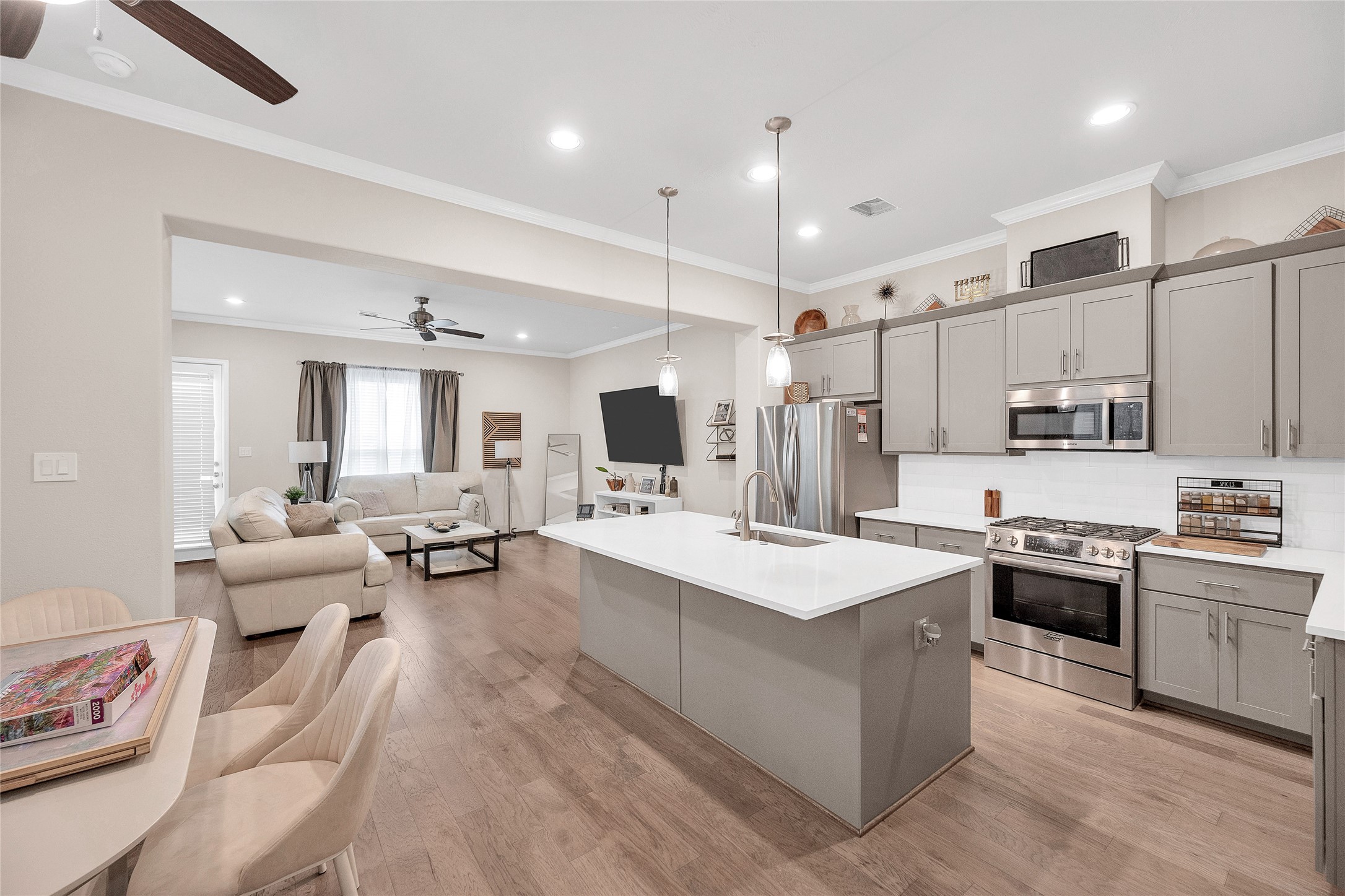 5014 Lillian Street Houston, TX 77007 - Photo 5 of 24 a large white kitchen with stainless steel appliances