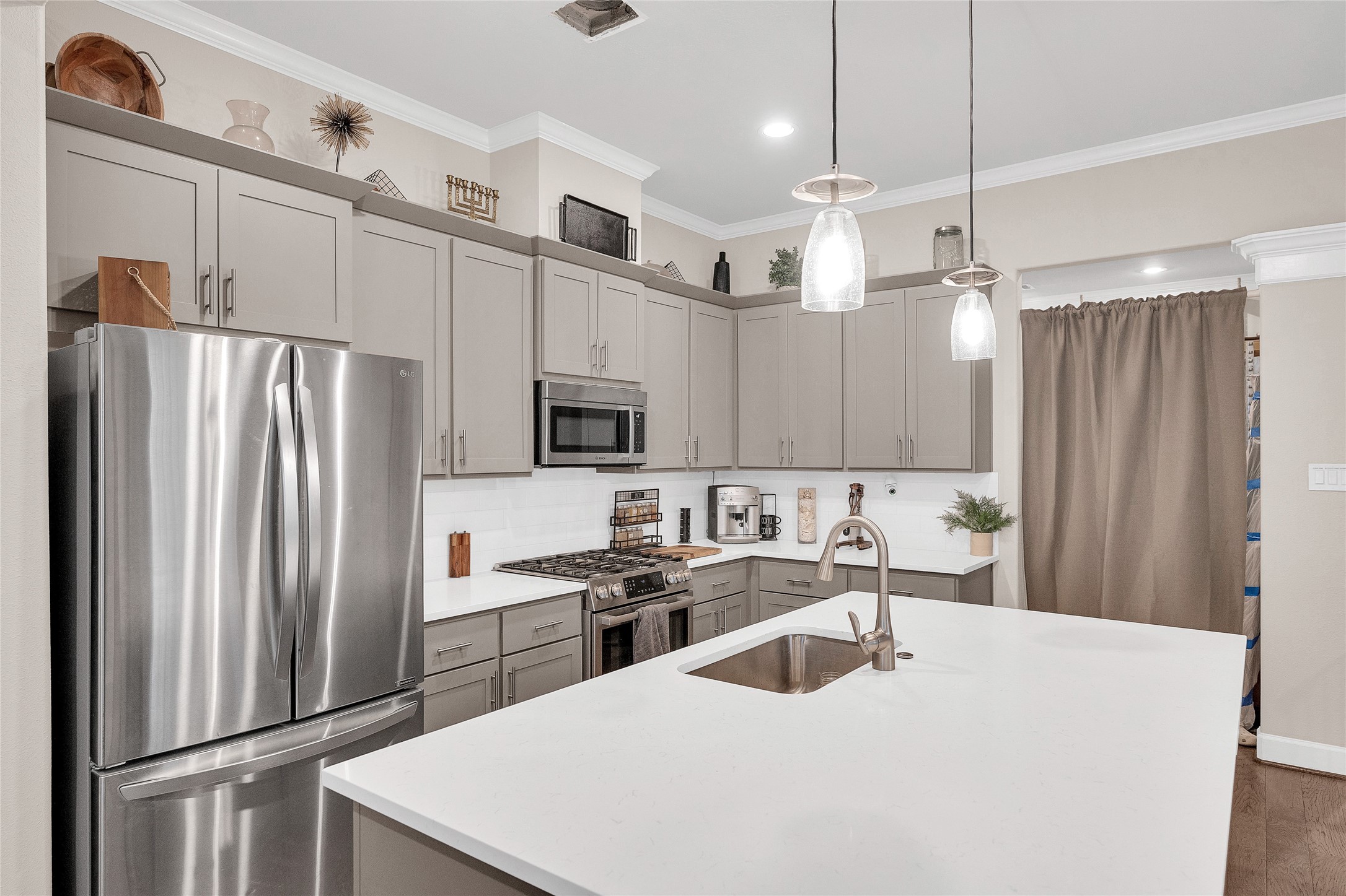 5014 Lillian Street Houston, TX 77007 - Photo 6 of 24 a kitchen with stainless steel appliances a refrigerator sink and microwave