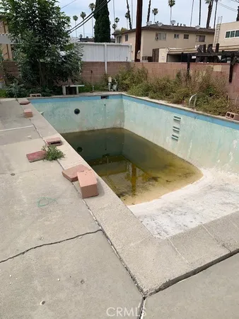 a view of a swimming pool with a yard