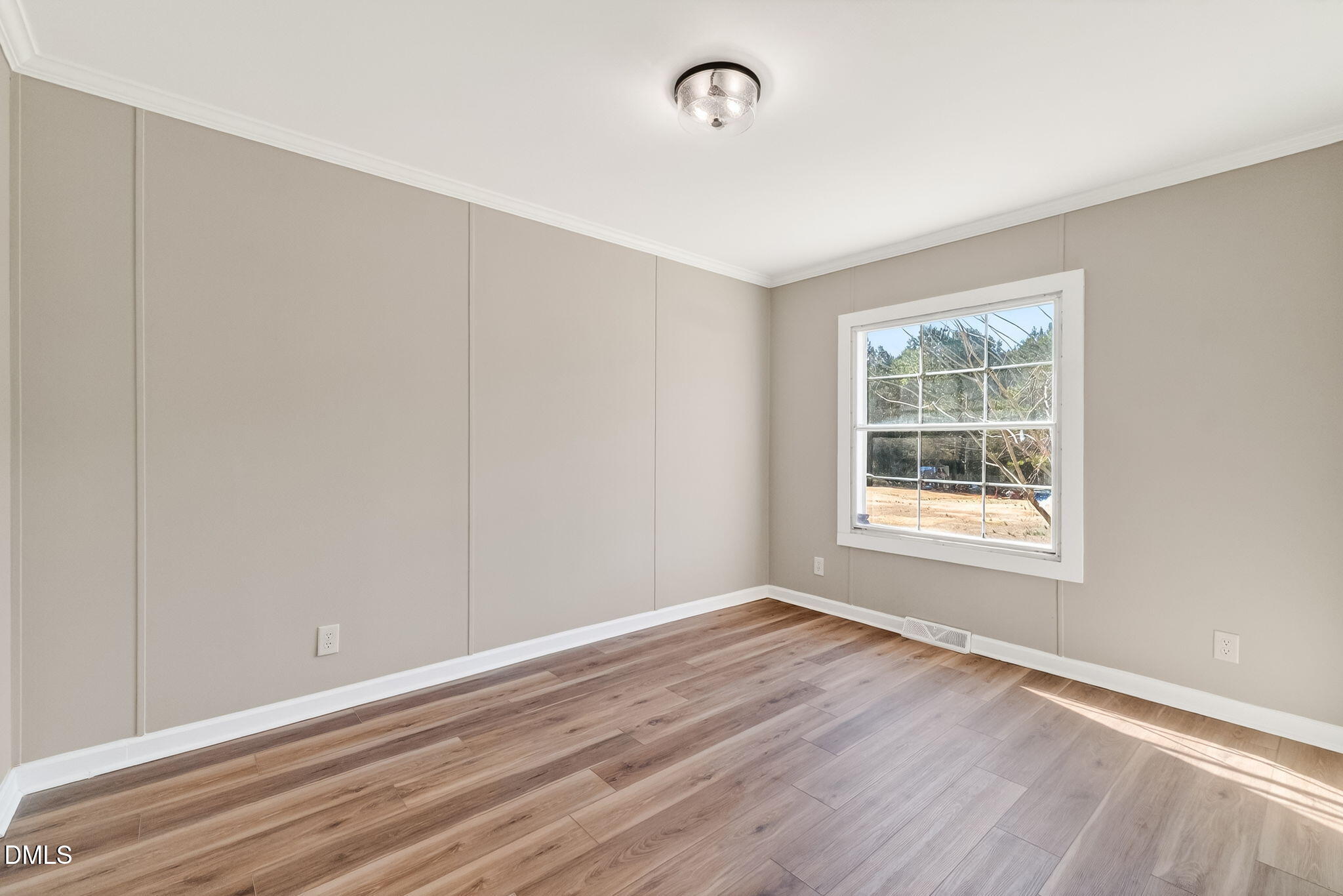 10015 Smith Road Middlesex, NC 27557 - Photo 32 of 48 a view of an empty room with wooden floor and a window