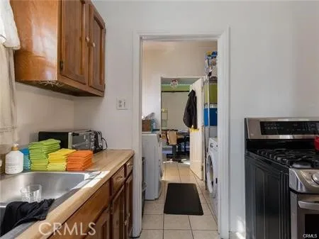 a kitchen with a sink a stove and cabinets