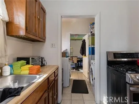 a kitchen with stainless steel appliances granite countertop a sink and a stove