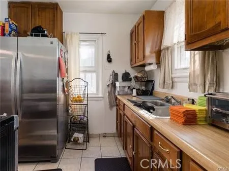a kitchen with stainless steel appliances granite countertop a refrigerator a stove and a sink