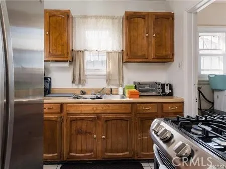 a kitchen with kitchen island granite countertop a stove and a sink