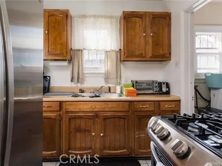 a kitchen with a stove and a refrigerator