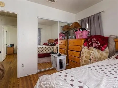 a bedroom with a bed and a closet