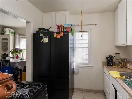 a kitchen with a refrigerator and a stove