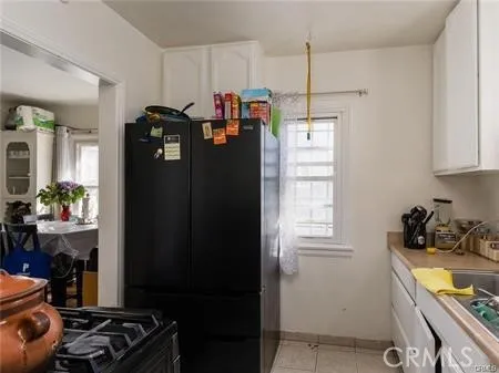 a kitchen with a refrigerator and a stove