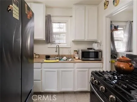a kitchen with stainless steel appliances granite countertop a stove a refrigerator and a sink