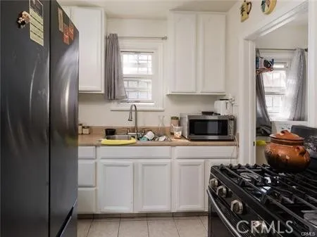 a kitchen with stainless steel appliances granite countertop a stove a refrigerator and a sink