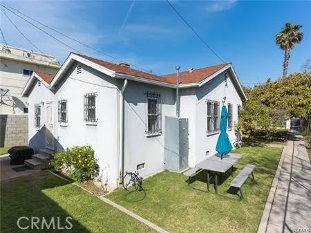 a backyard of a house with table and chairs