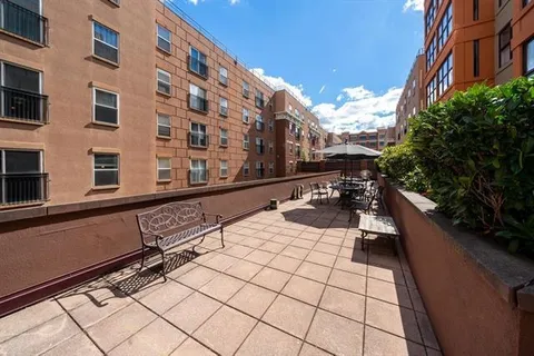 a view of a building with sitting area